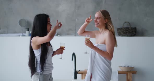 Beautiful Blonde Woman Wrapped in White Towel and Her Asian Cute Friend Chilling Together at alt