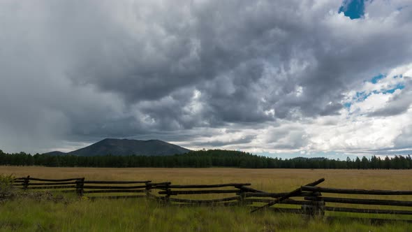 Storm Building Over Meadow and Mountain alt