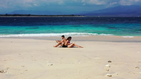 Man and lady tan on relaxing seashore beach journey by turquoise lagoon with white sandy background 