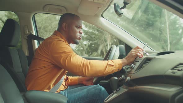 Male Driver Using Smartphone for Gps Navigation in Car alt