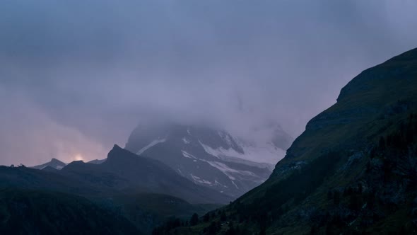Timelapse of clouds clearing at sunset over the Matterhorn Mountain Switzerland alt