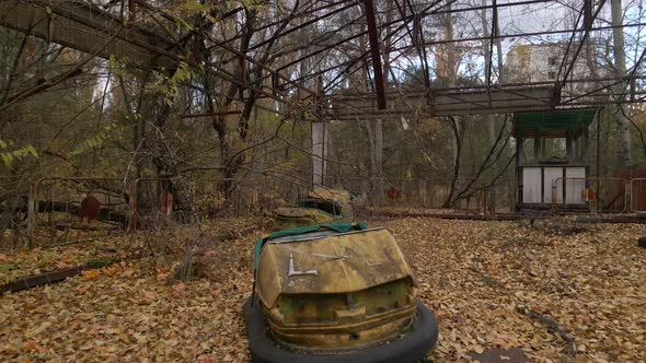 Decayed Autodrome with bumper cars in ghost town Pripyat in radioactive chernobyl exclusion zone alt