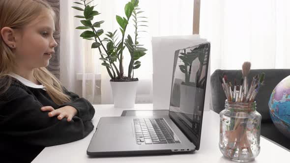 Girl Using Laptop for Video Lesson