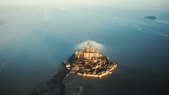 Drone Flying Very High Above Majestic Sunrise Mont Saint Michel, Unreal Castle Island Surrounded alt