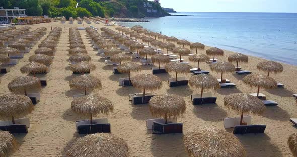 Drone View on Reed Umbrellas on the Sandy Beach Bulgaria