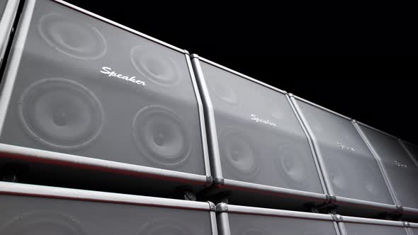 Playing cabinet speakers stacked on a stage in form of an endless wall pattern.