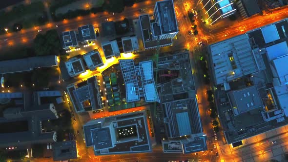 AERIAL: Birds View of Big City Construction Site at Night,City Lights, Traffic,Movement alt