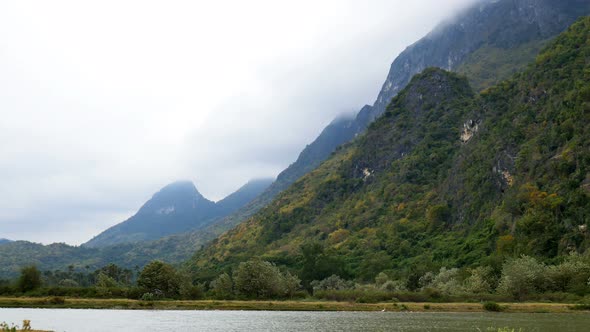 Mountain With Forest And Pond In Cloudy Day alt