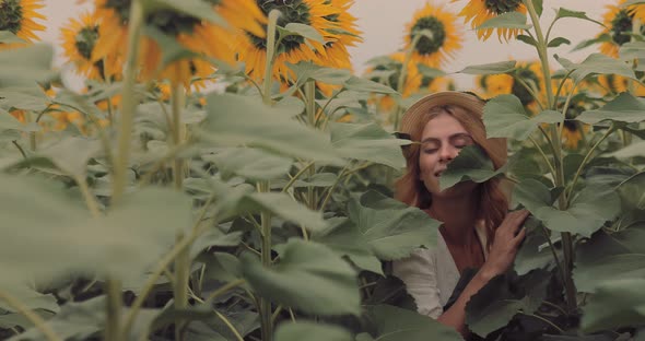 Beautiful Girl Sneaks Through Tall Sunflowers