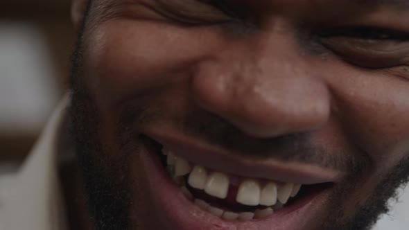 Sincere Smile Laugh of an Adult Africanamerican Man in Extreme Closeup in Slow Motion alt