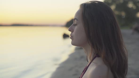 Close-up Face of Concentrated Young Beautiful Woman Breathing in and Out Raising Hands. Portrait of alt