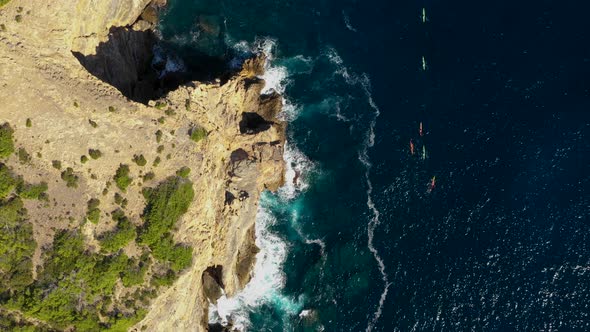 A Group of Athletes Swim in a Kayaks Around the Eastern Cape of the Island of Ibiza