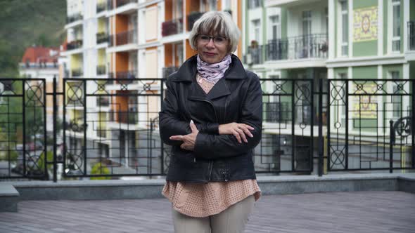 Front View Portrait Confident Beautiful Senior Slim Woman Posing Outdoors on City Street alt