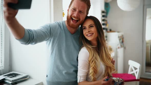 Beautiful Couple Smiling and Taking Selfies at Home