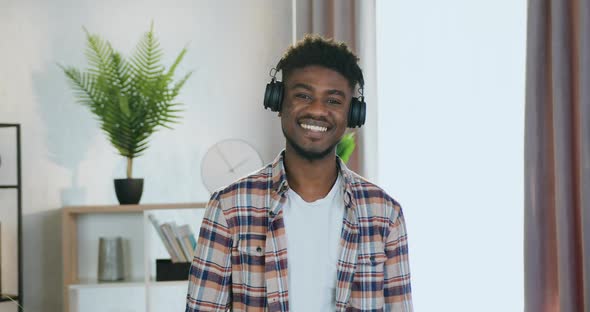 Black-Skinned Guy in Headphones which Standing in front of camera alt