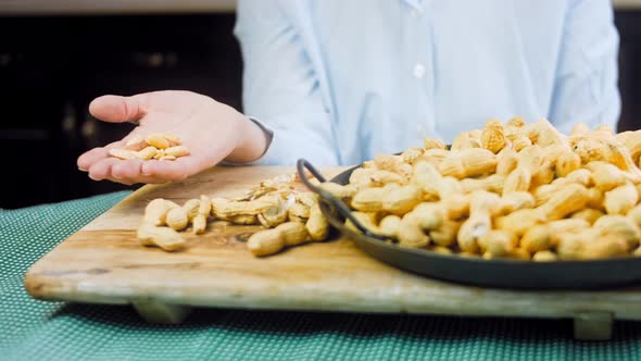 The Woman Peels the Peanuts From the Retro Tray alt