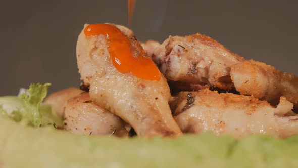 Red Chili Sauce Is Poured Over Fresh Hot Grilled Poultry