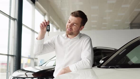 Portrait of Happy Adult Successful Man Posing in Auto Showroom Buying New Automobile alt