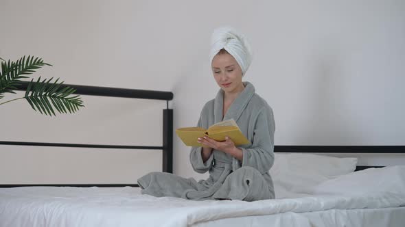 Female Reads Novel in Bedroom