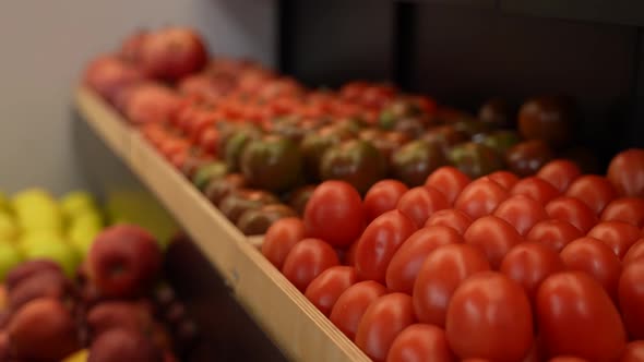Female Hand Taking Vegetables From Store Shelf alt
