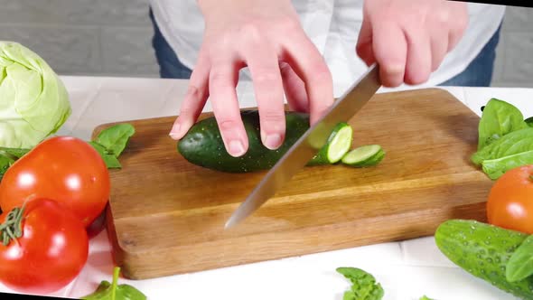 Close-up video of cutting cucumbers