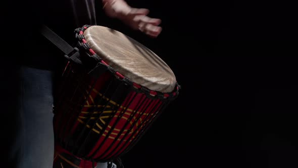 Black Man Plays Drum with Hands Closeup in Studio alt