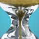 An Hourglass Made of Yellow Metal Shavings Passes Through a Funnel Symbolizing the Concept of Time - VideoHive Item for Sale