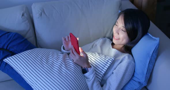 Woman use of mobile phone at home alt