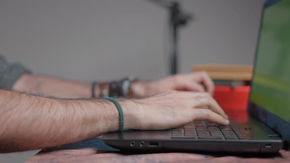 Hairy Hands Typing in a Computer with a Green Screen alt