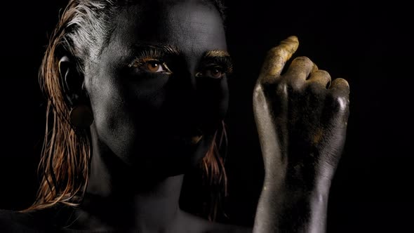 Portrait of a Young Woman with Magical Black Skin and Golden Hands alt