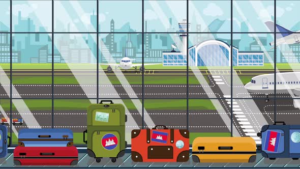 Suitcases with Cambodian Flag Stickers on Baggage in Airport alt