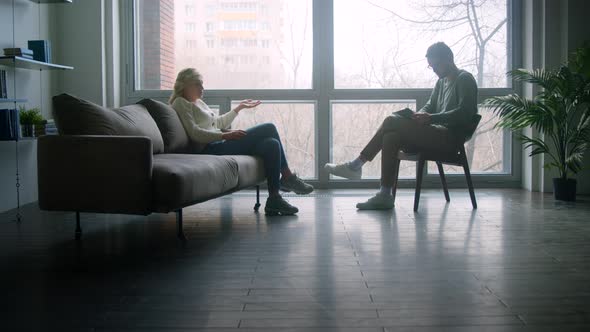 Young doctor listening to the story of the patient at the psychological session in the office alt