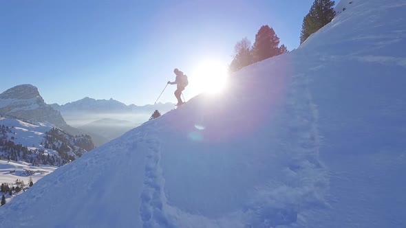Man snowshoeing in the dolomites at sunrise alt