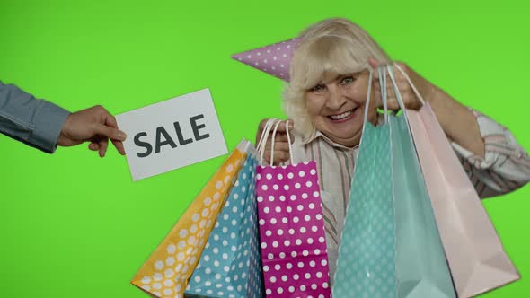 Inscription Advertising Sale Word Appears Next To Joyful Grandmother with Shopping Bags. Chroma Key alt