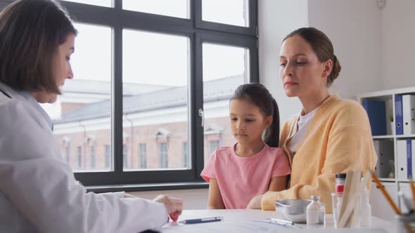 Mother with Little Daughter and Doctor at Clinic alt