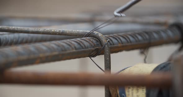 Close Up of a Worker Securing the Metal Rods with Wire Construction Site alt