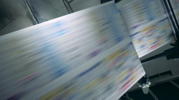 Fake News Concept. Uncut Printed Paper Rolling Through the Factory Machine alt