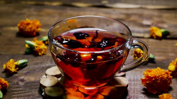 Antioxidant Red Tea On A Wooden Table, Natural From Marigold Flowers, Top View, Tea For Colds. alt
