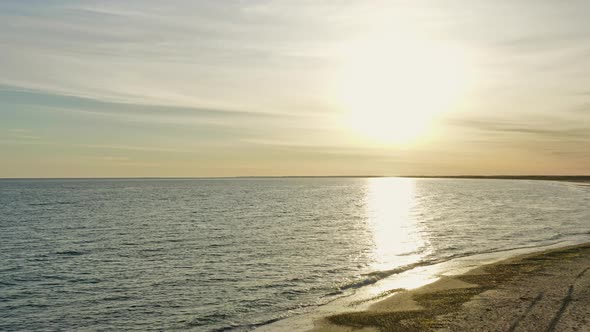 Breathtaking Wide Shot of Ocean Waters and Suns Reflection By the Jutland Beach alt