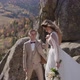 Majestic View of Rock Mountain and Beautyiful Newlyweds Who Approach to Each Other - VideoHive Item for Sale