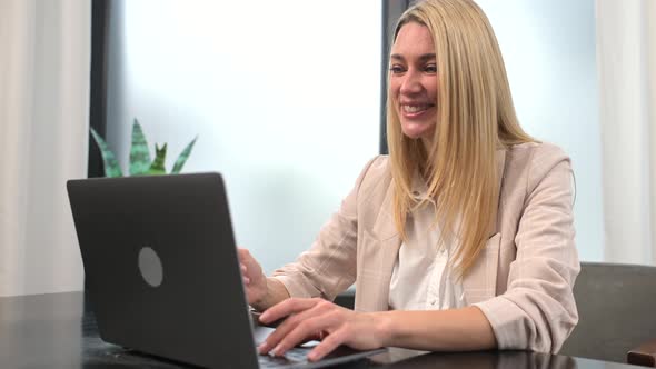 Happy Young Nice Woman Looking at the Laptop Screen Holding Video Call Meeting