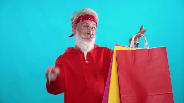 Grayhaired Adult Man in a Red Hoodie Makes Successful Purchases Online Using a Credit Card a Stylish alt