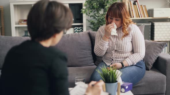 Depressed Young Obese Woman Crying Talking To Psychotherapist in Office alt