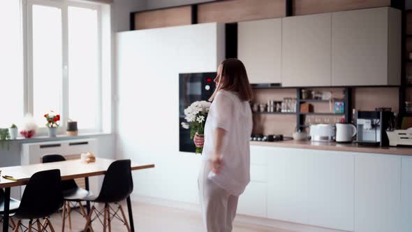 Beauty Delicate Woman Enjoys a Bouquet of White Flowers