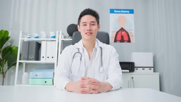 Asian male medical doctor talking virtual online with patient at home. alt
