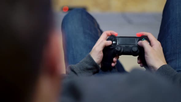 Closeup View of Man's Hands Playing Video Game at Home alt