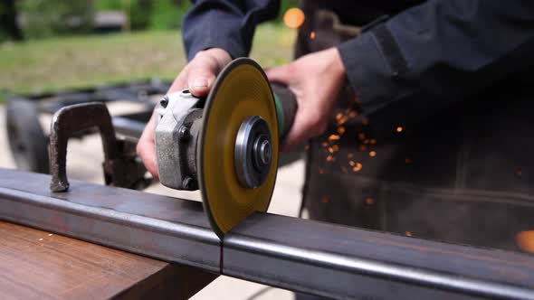 A Metal Surface Being Cut Through a Grinding Wheel alt