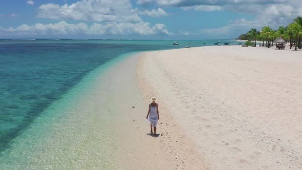 Girl Walking on a White Sand Beach on a Tropical Island in the Mauritius Indian Ocean alt