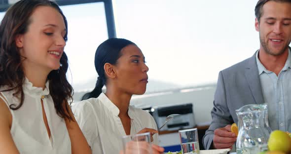 Group of business executives having breakfast alt