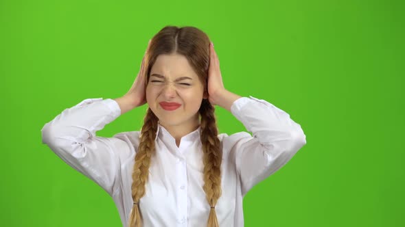 Schoolgirl Closes His Ears From the Noise. Green Screen alt